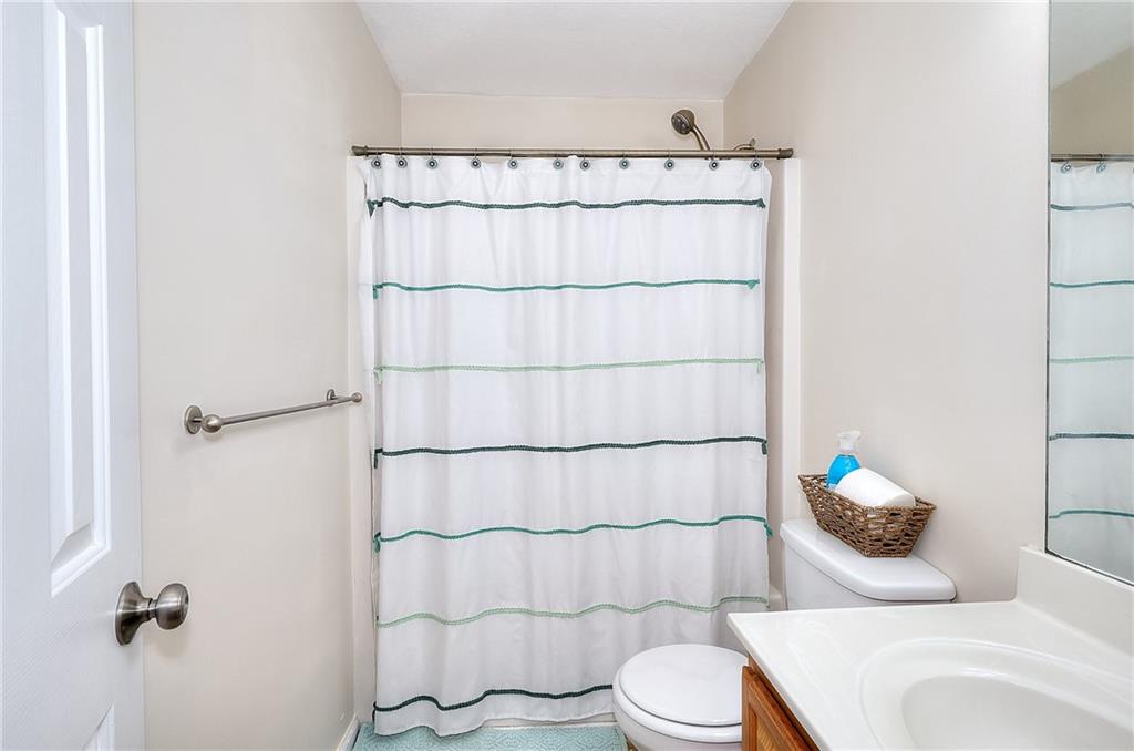 148 Alice Walker Drive Athens, GA 30607 - Photo 22 of 28 a bathroom with a toilet and a shower curtain