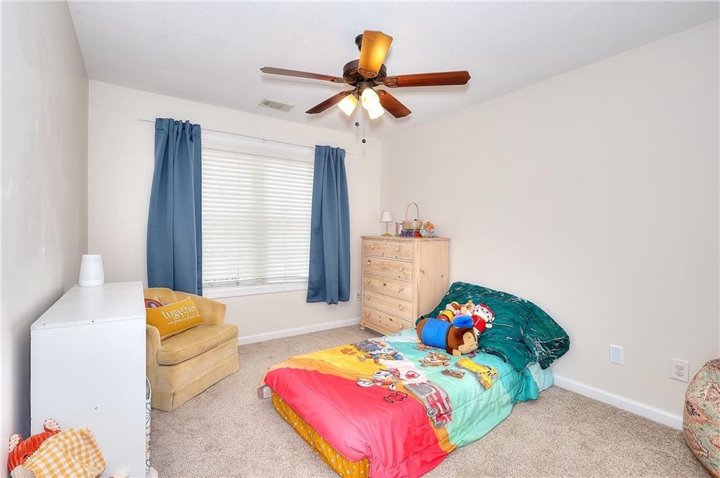 148 Alice Walker Drive Athens, GA 30607 - Photo 25 of 28 a bedroom with a bed and a chandelier