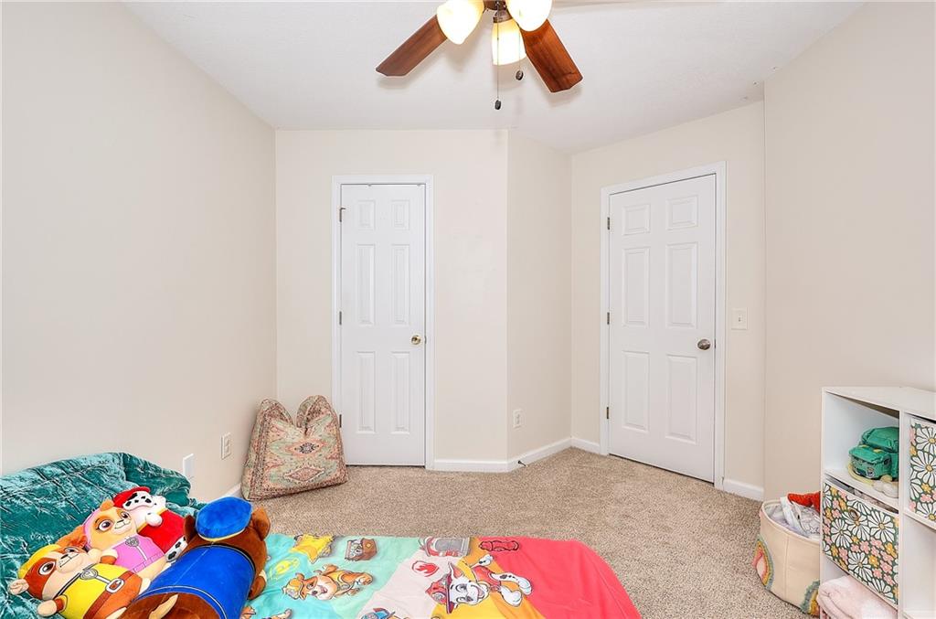 148 Alice Walker Drive Athens, GA 30607 - Photo 26 of 28 a bedroom with a bed and a dresser in it