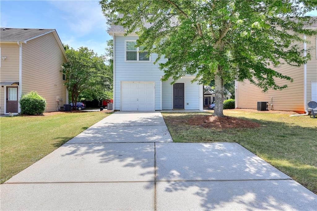 148 Alice Walker Drive Athens, GA 30607 - Photo 27 of 28 a front view of a house with a yard and garage