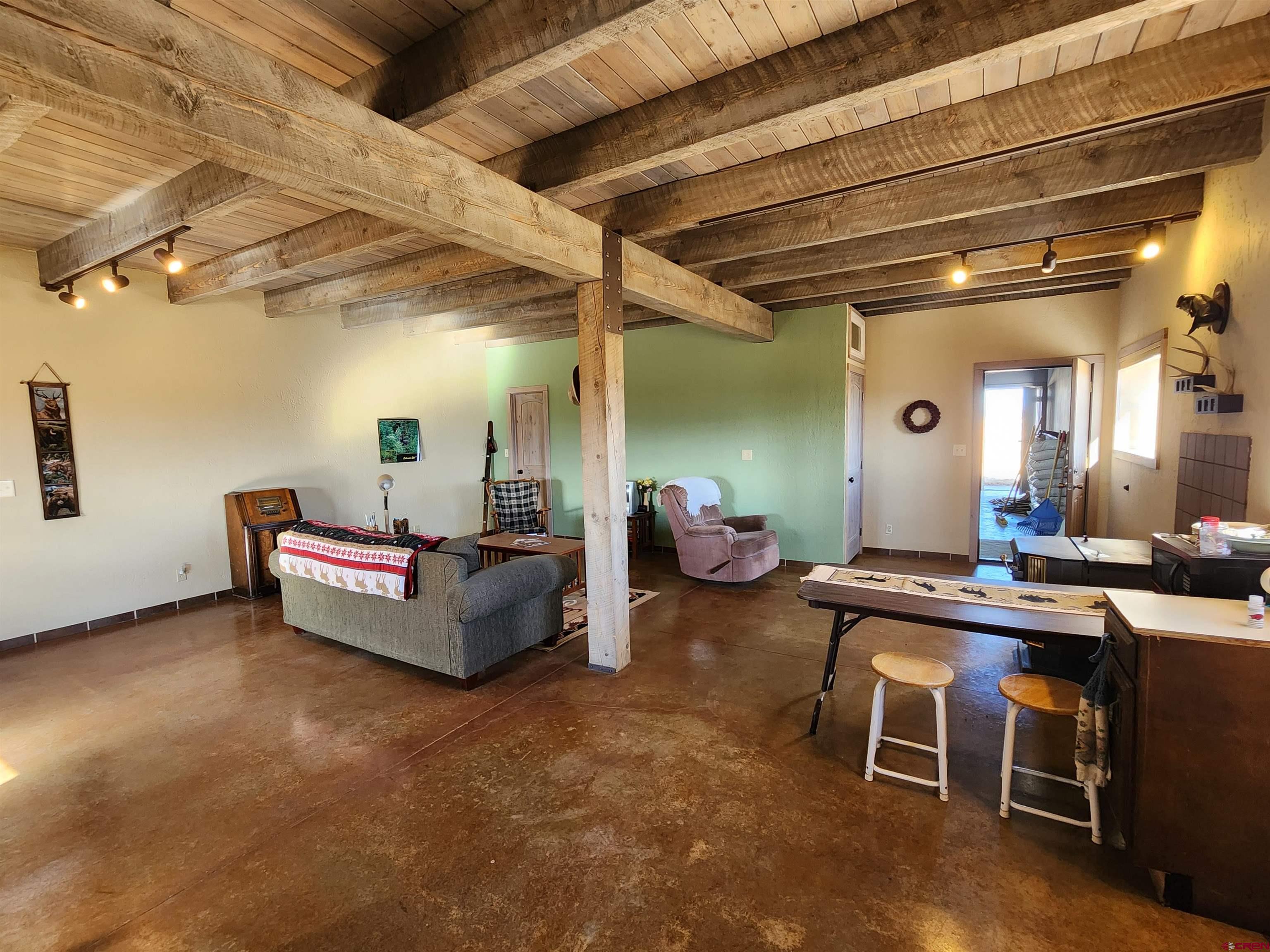 1935 Henderson Road Monte Vista, CO 81144 - Photo 16 of 23 a living room with furniture and a table