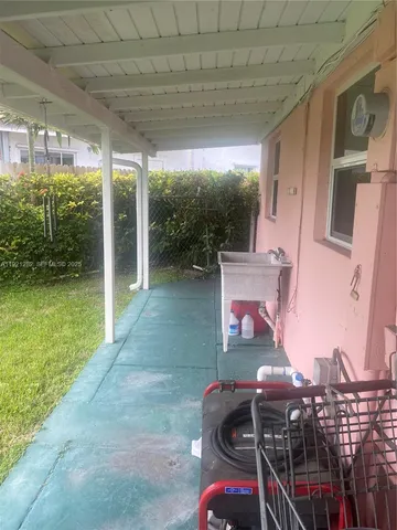 a view of yard from deck with patio