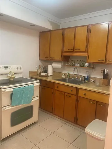 a kitchen with a sink stove and cabinets