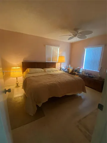 a bedroom with a bed and a lamp with window