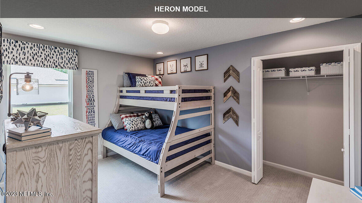 65776 Edgewater Drive Yulee, FL 32097 - Photo 17 of 45 a bedroom with furniture and a chandelier