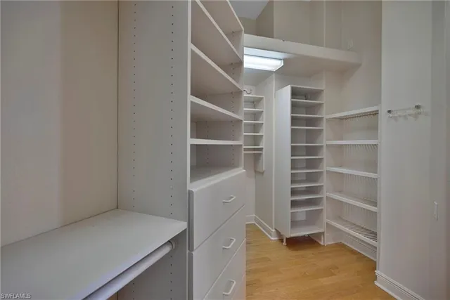 a view of walk in closet with empty racks