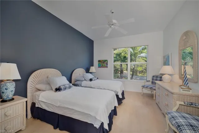 a bedroom with two beds and a chandelier