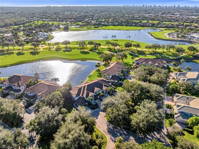 an aerial view of residential houses with outdoor space and river