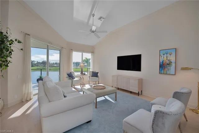 a living room with furniture a large window and a flat screen tv