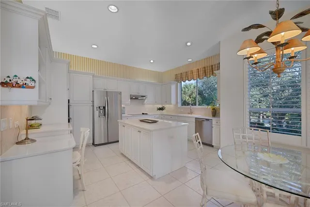 a kitchen with a sink and a stove top oven