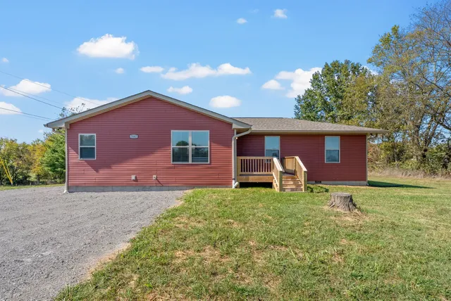 a house view with a sitting space and garden