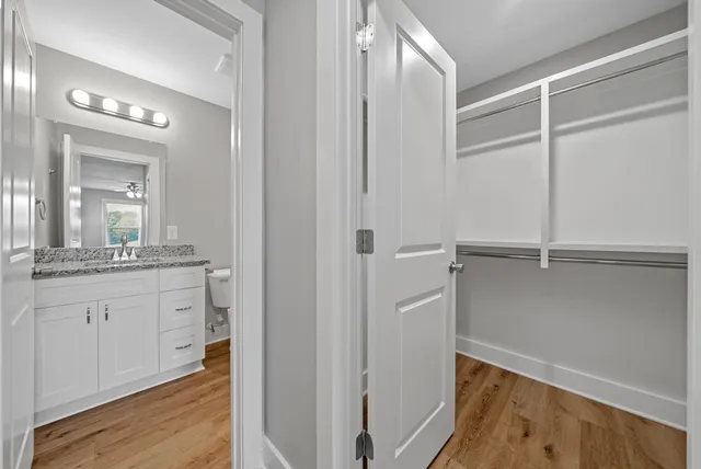a bathroom with a granite countertop sink mirror and vanity