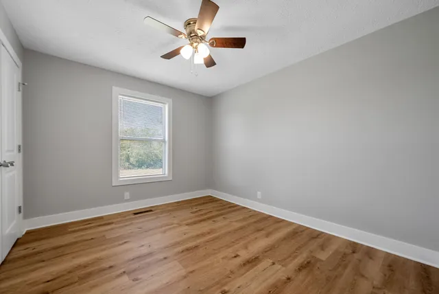 wooden floor in an empty room with a window