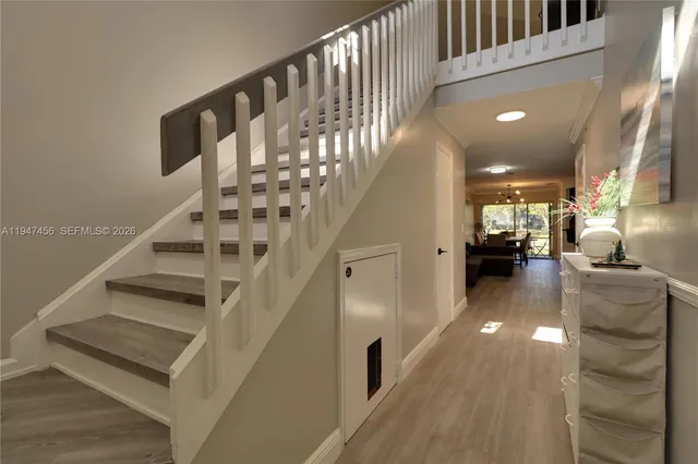a view of entryway and hall with wooden floor