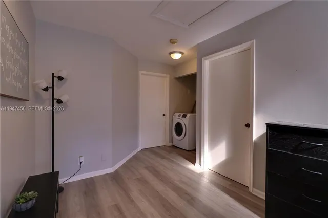 a view of empty room with wooden floor