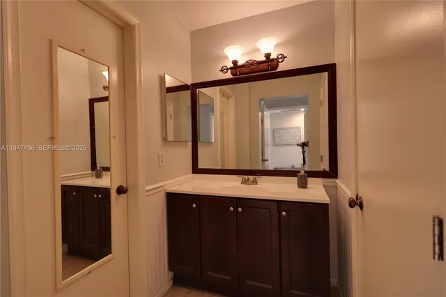 a bathroom with a sink and a mirror