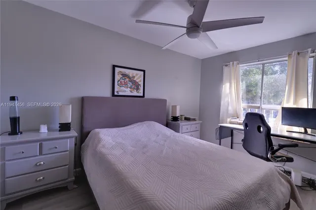 a bedroom with a bed and a desk