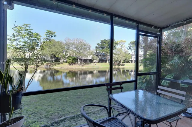 a balcony with table and chairs