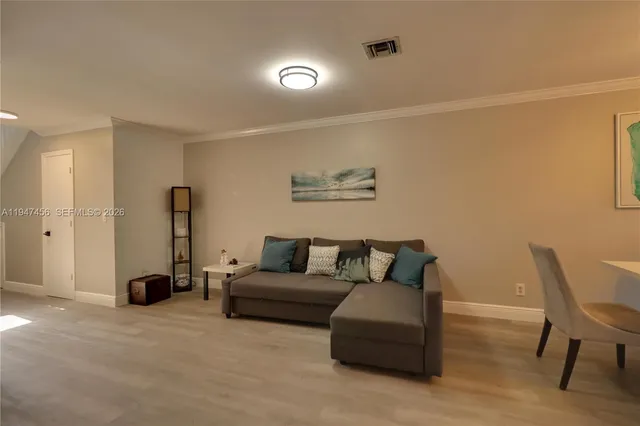 a living room with furniture a couch and a potted plant