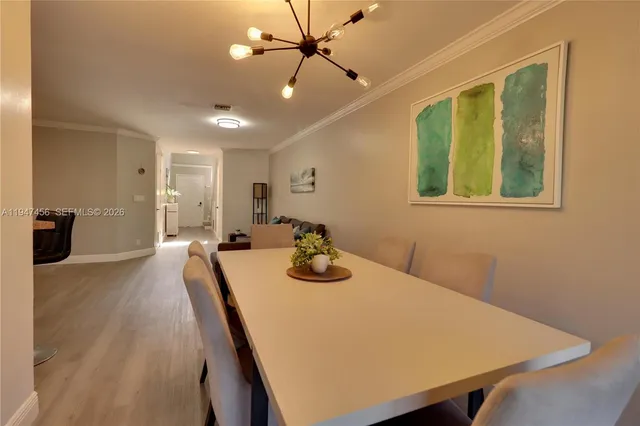 a view of a dining room with furniture and a window