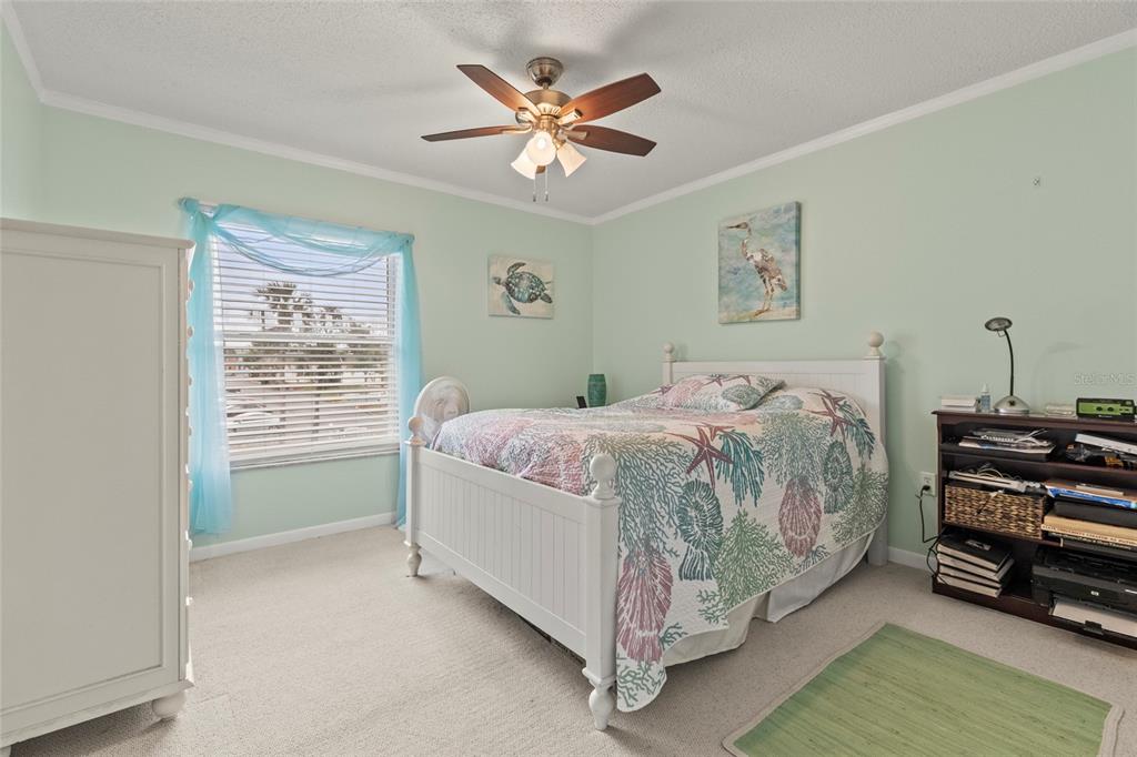12760 Indian Rocks Road, Unit 571 Largo, FL 33774 - Photo 26 of 39 a bedroom with a bed and a chandelier