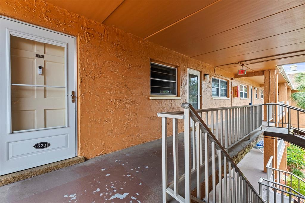 12760 Indian Rocks Road, Unit 571 Largo, FL 33774 - Photo 5 of 39 a view of a porch with wooden floor and windows