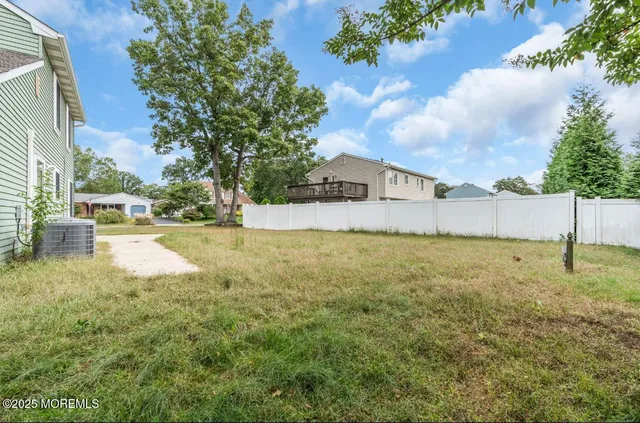 a view of yard with swimming pool and green space