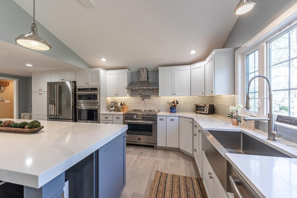 21 Gleason Road Reading, MA 01867 - Photo 3 of 42 a kitchen with stainless steel appliances a sink stove and refrigerator