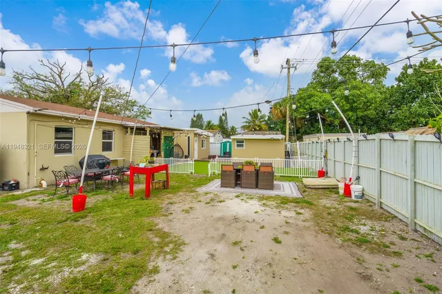 a view of yard with swimming pool and sitting area