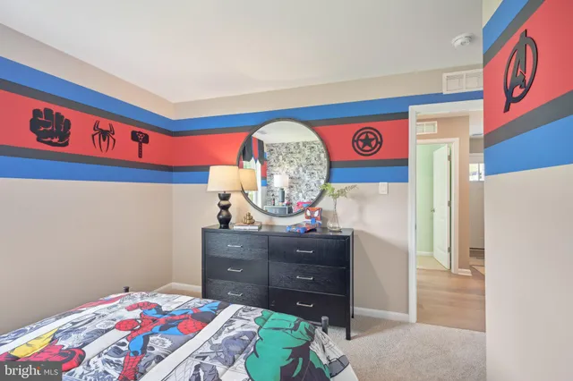 a bedroom with a bed and a dresser in it