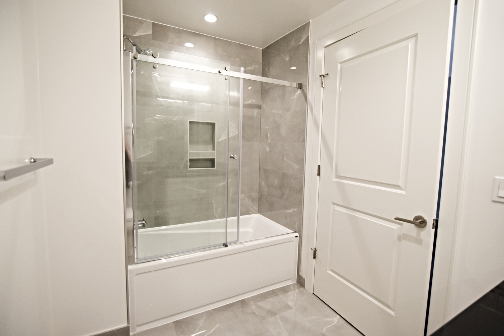 3833 North Broadway, Unit 409 Chicago, IL 60613 - Photo 13 of 14 a bathroom with a bathtub and a shower