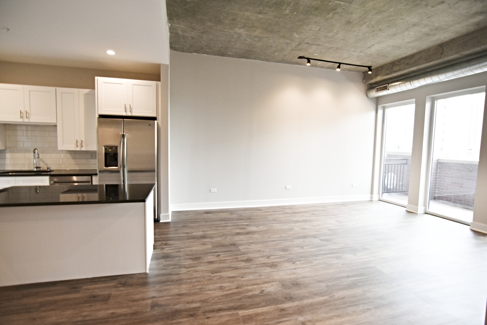 3833 North Broadway, Unit 409 Chicago, IL 60613 - Photo 3 of 14 a kitchen with granite countertop a refrigerator and a stove