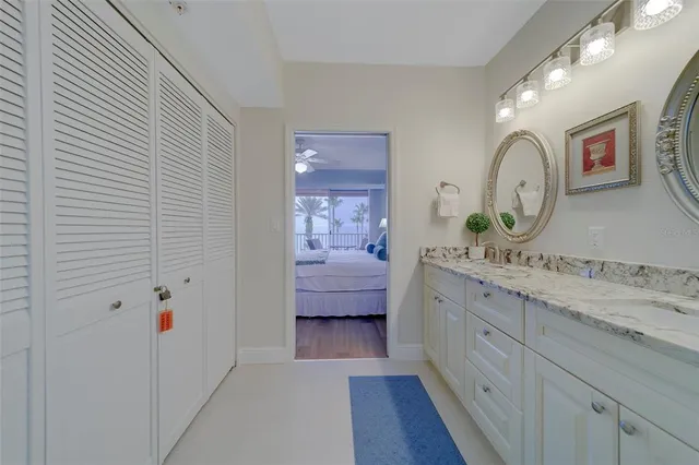 a bedroom with two beds and potted plant