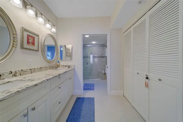 a bedroom with a bed lamp and a potted plant