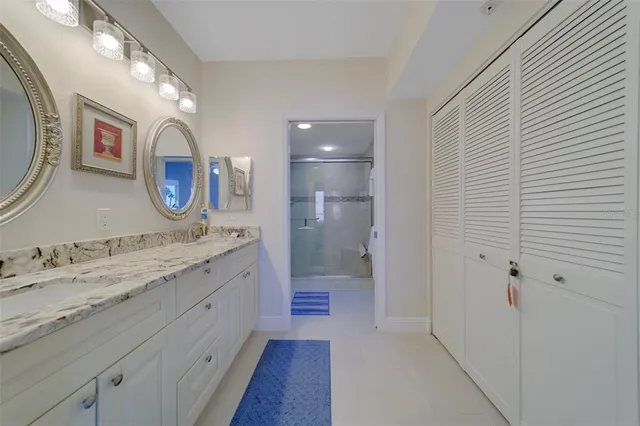 a bedroom with a bed lamp and a potted plant