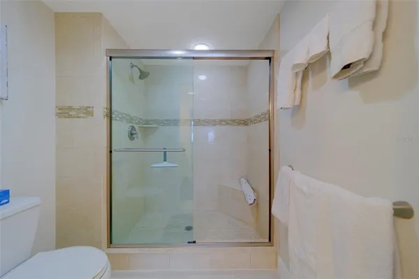 a bathroom with a bathtub shower sink vanity and toilet