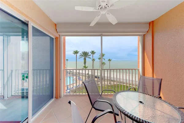 a living room with furniture a flat screen tv and a table