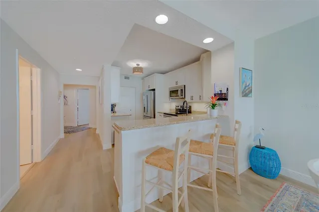 a kitchen with refrigerator cabinets and a sink