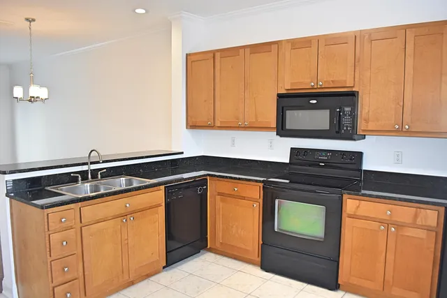 a kitchen with granite countertop a sink and cabinets