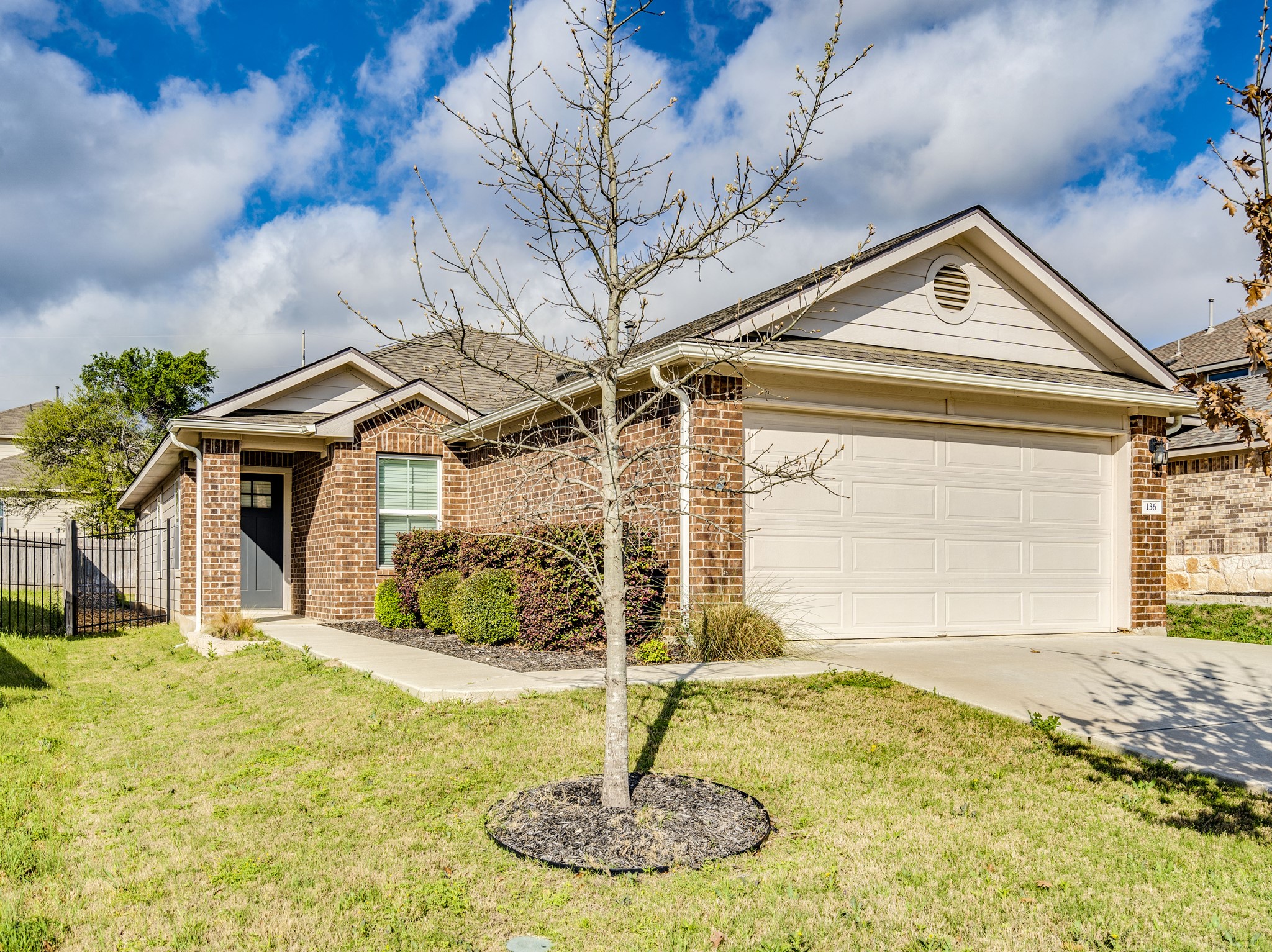 136 Dunlin Lane Leander, TX 78641 - Photo 1 of 24 Ranch-style house with brick siding, concrete driveway, and a garage