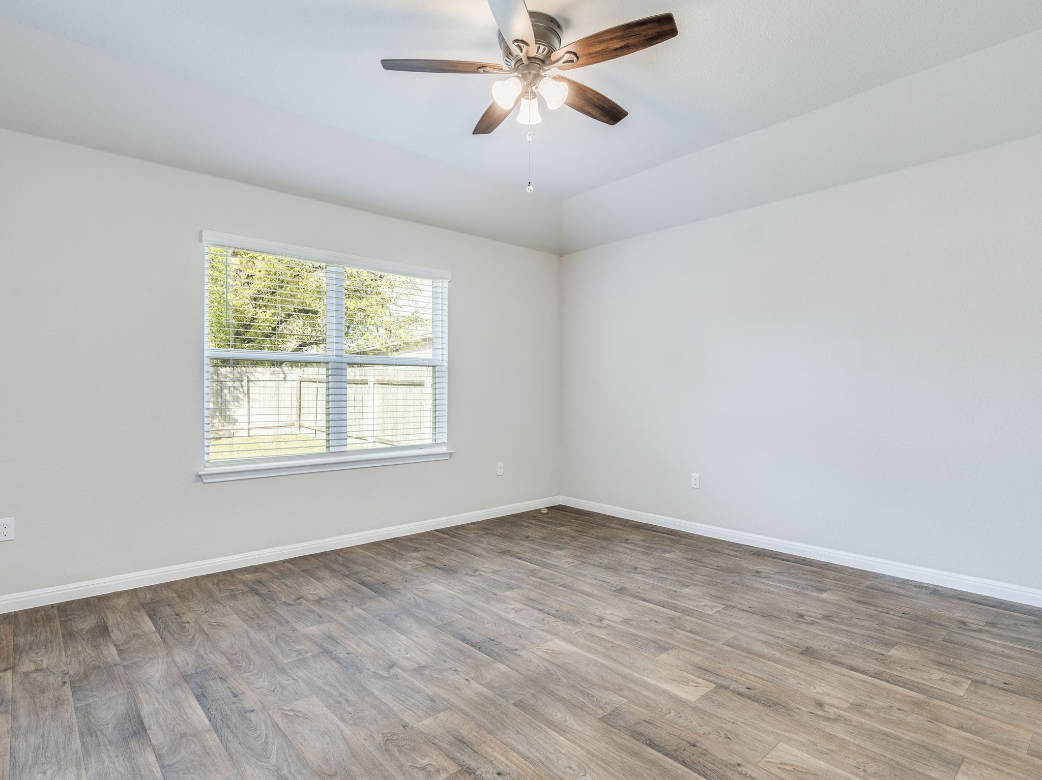 136 Dunlin Lane Leander, TX 78641 - Photo 11 of 24 Empty room featuring light wood-style flooring, a ceiling fan, and lofted ceiling
