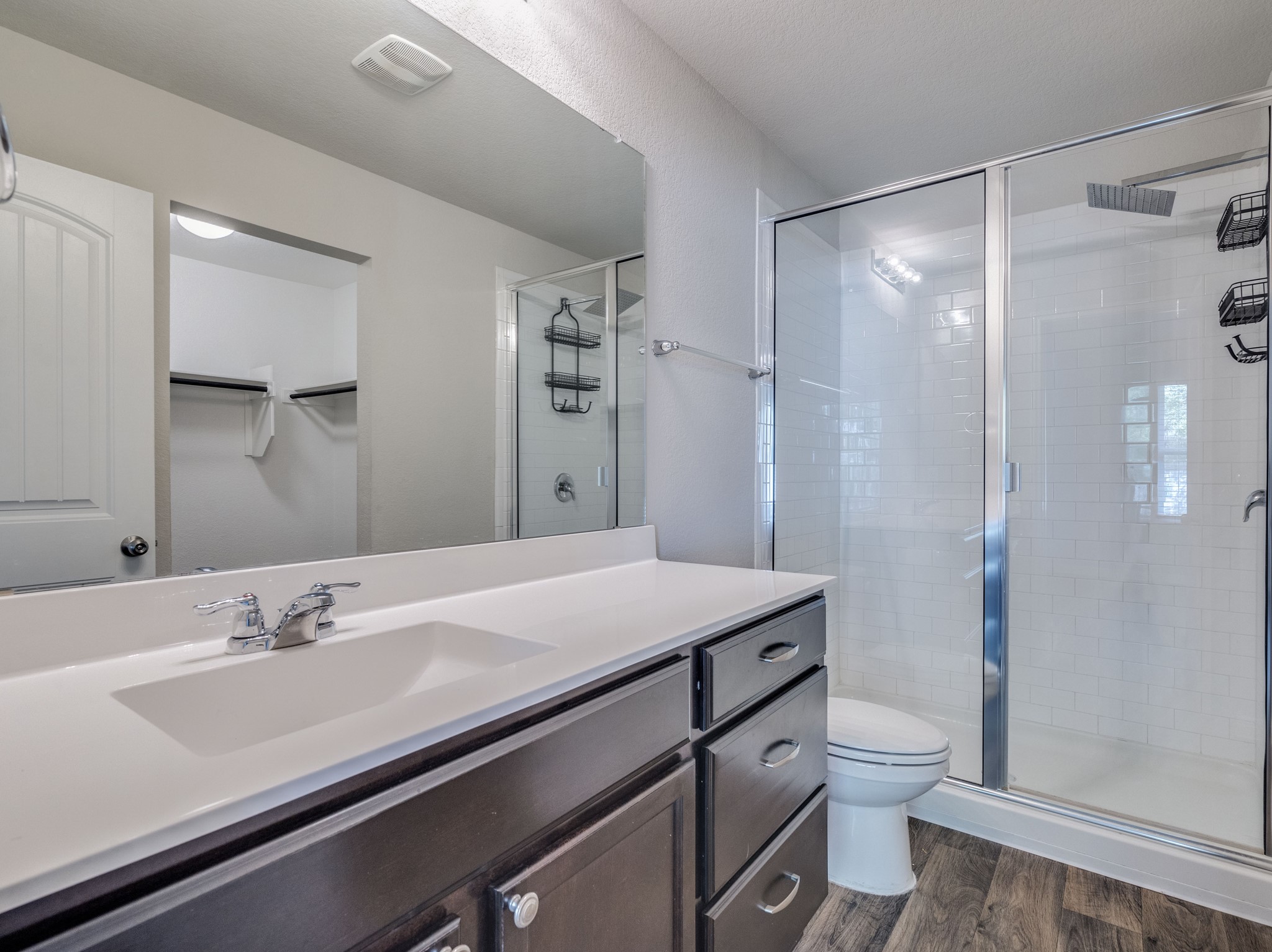 136 Dunlin Lane Leander, TX 78641 - Photo 13 of 24 Full bathroom with a shower stall, vanity, and dark wood finished floors