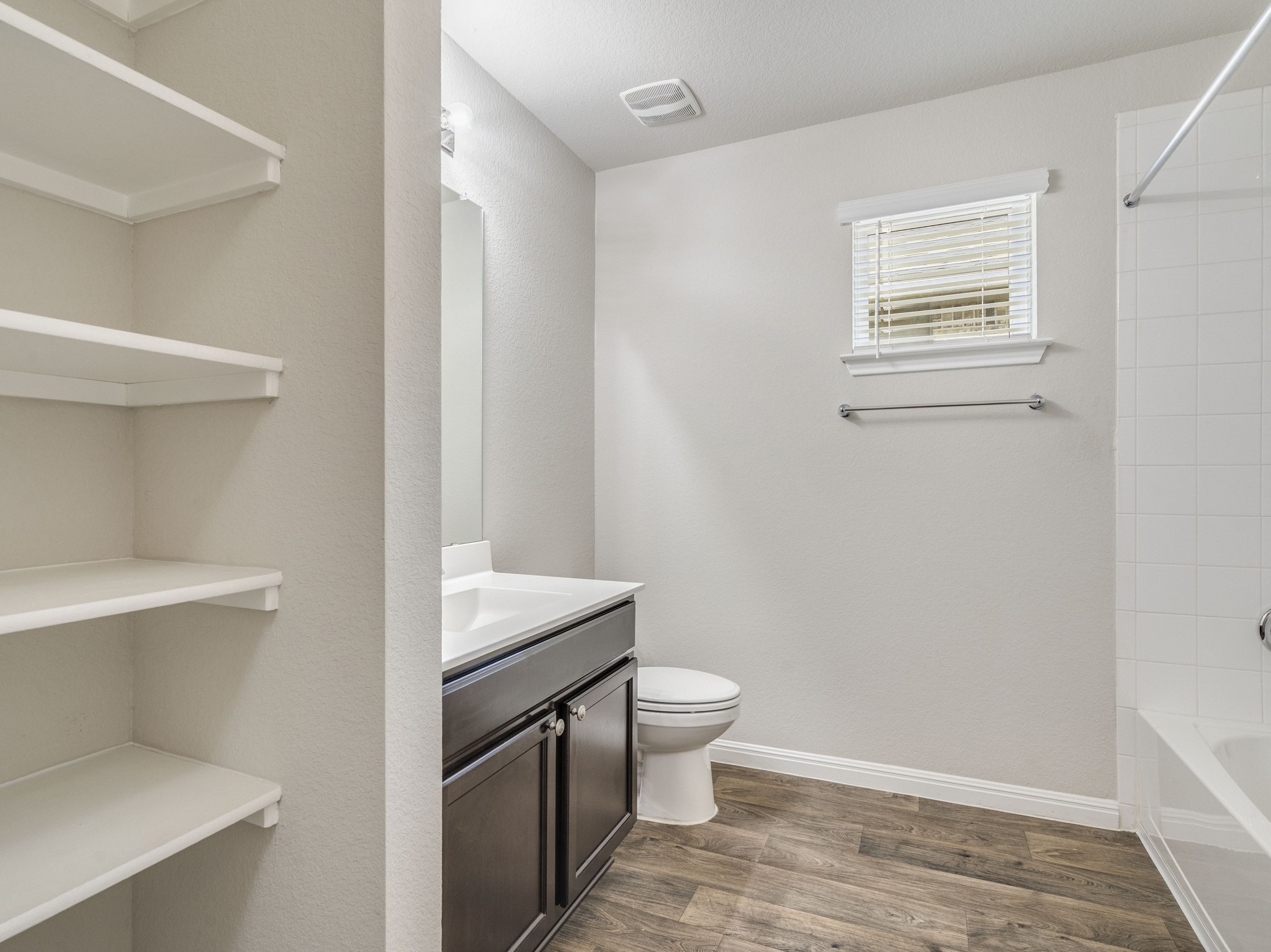 136 Dunlin Lane Leander, TX 78641 - Photo 20 of 24 Bathroom featuring vanity, dark wood-style flooring, and bathing tub / shower combination