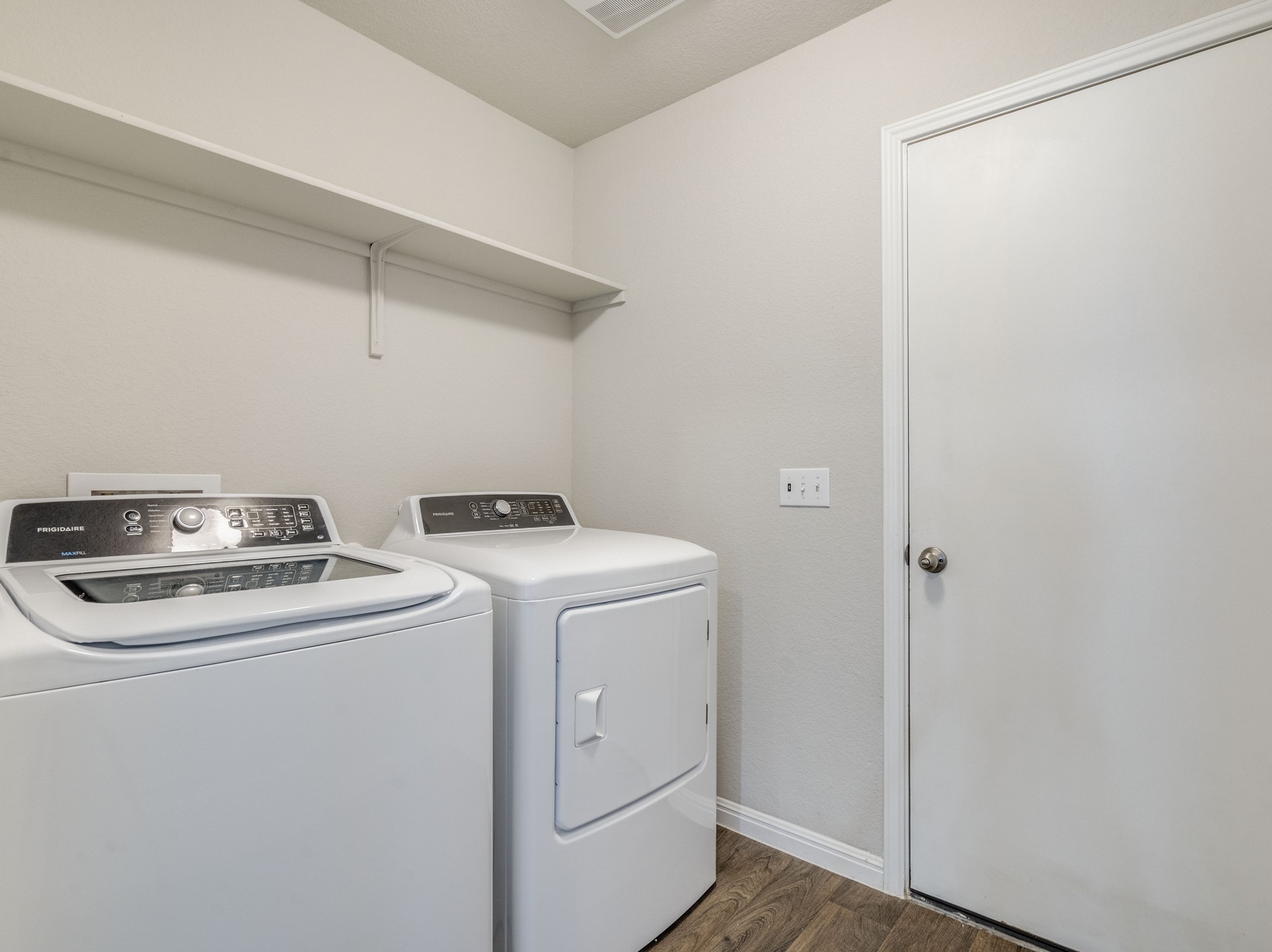 136 Dunlin Lane Leander, TX 78641 - Photo 21 of 24 Laundry room with dark wood finished floors and washer and dryer