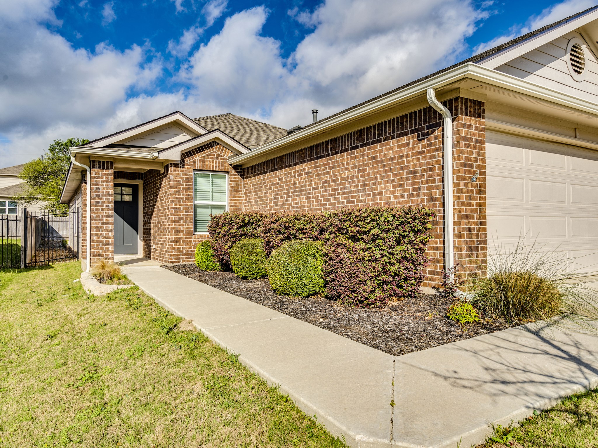 136 Dunlin Lane Leander, TX 78641 - Photo 3 of 24 View of front of home featuring brick siding, a garage, and a shingled roof