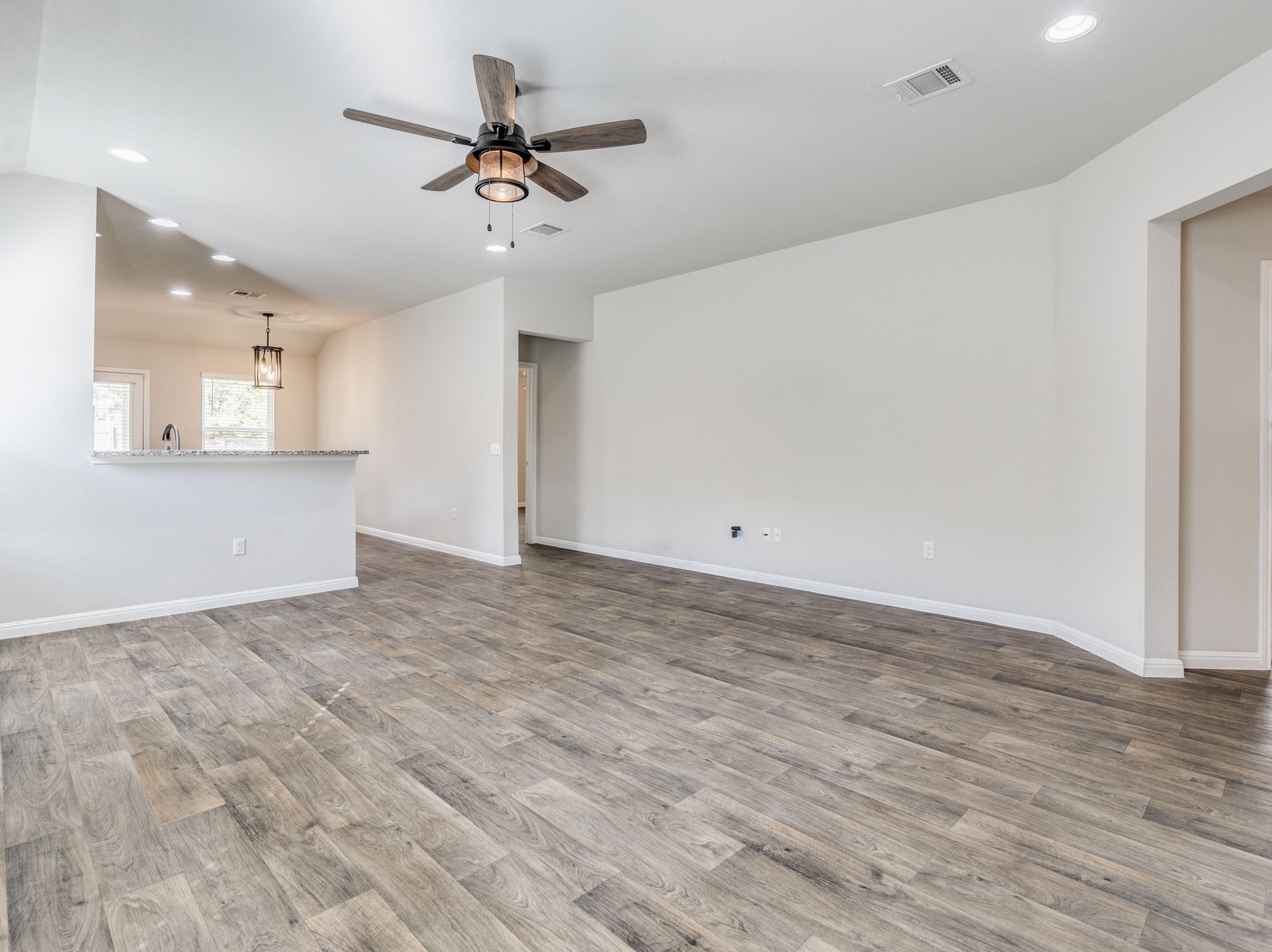 136 Dunlin Lane Leander, TX 78641 - Photo 4 of 24 Unfurnished living room featuring recessed lighting, ceiling fan, and light wood-type flooring