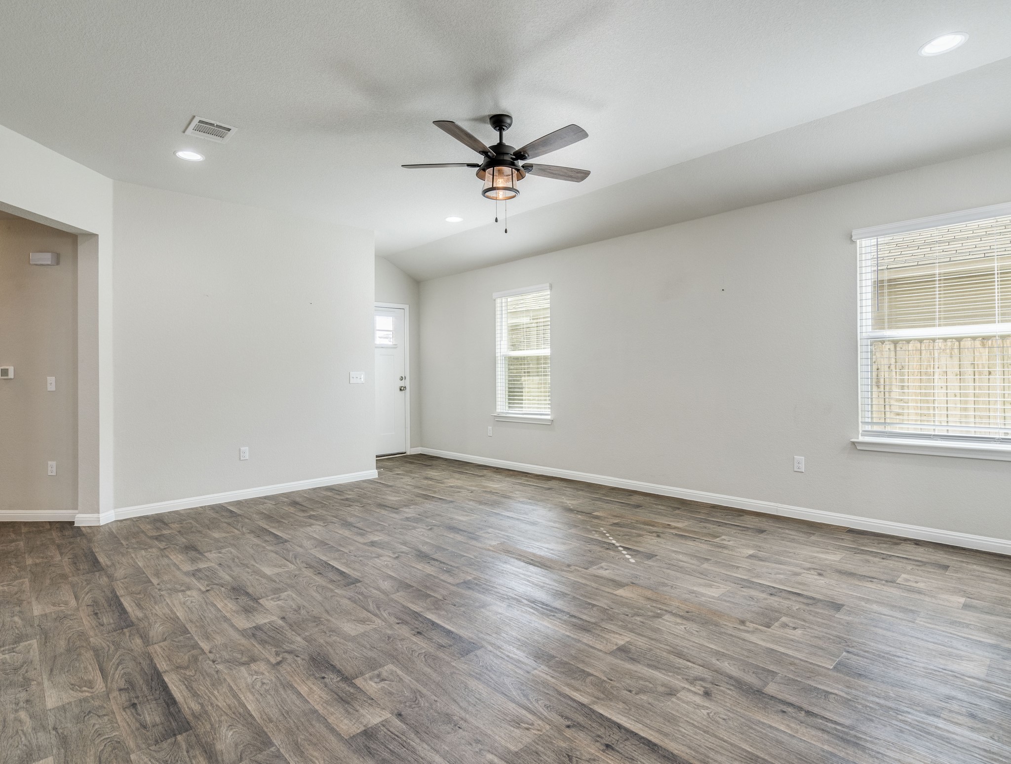 136 Dunlin Lane Leander, TX 78641 - Photo 6 of 24 Unfurnished room with ceiling fan, recessed lighting, dark wood-type flooring, and lofted ceiling