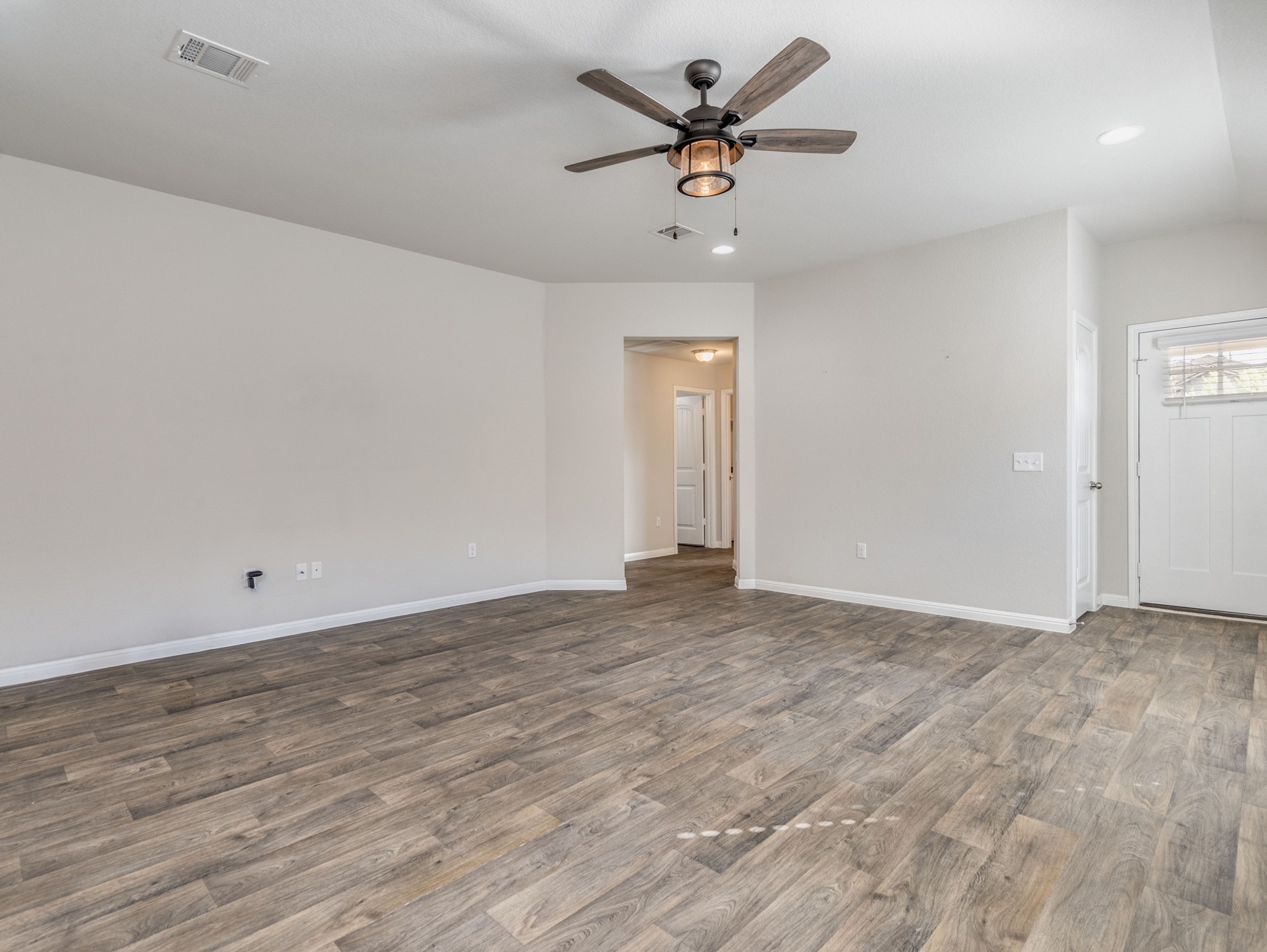 136 Dunlin Lane Leander, TX 78641 - Photo 7 of 24 Unfurnished room with ceiling fan, dark wood-style floors, and recessed lighting