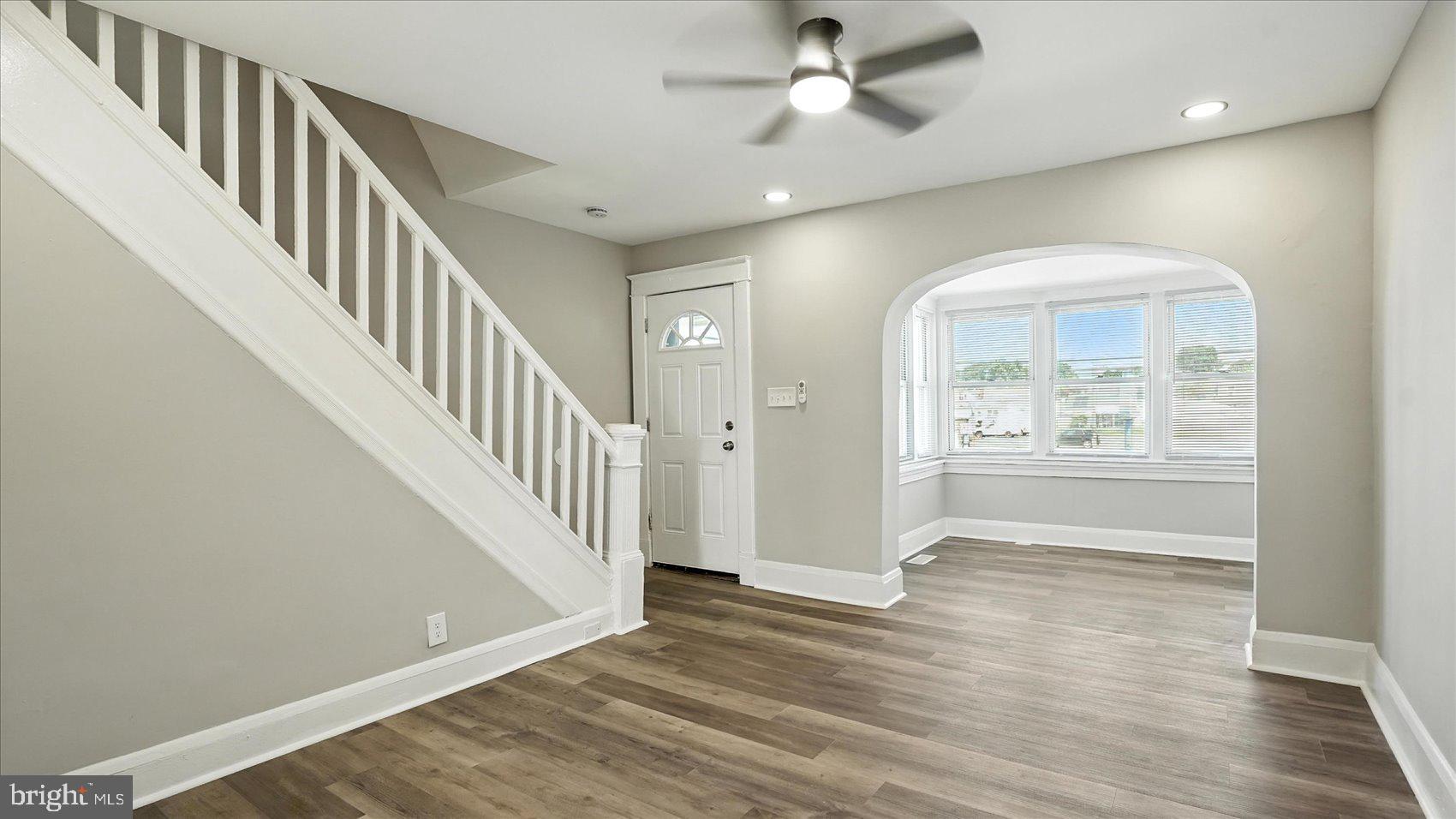 111 Eastern Boulevard Essex, MD 21221 - Photo 6 of 33 an empty room with wooden floor fan and windows