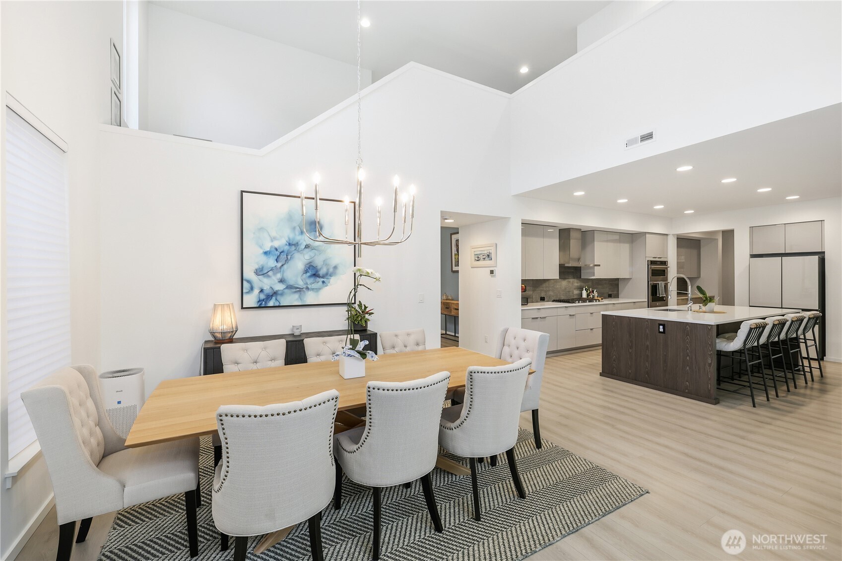 5661 Great Gln Road Southwest Port Orchard, WA 98367 - Photo 7 of 40 a dining room with furniture a rug and kitchen view